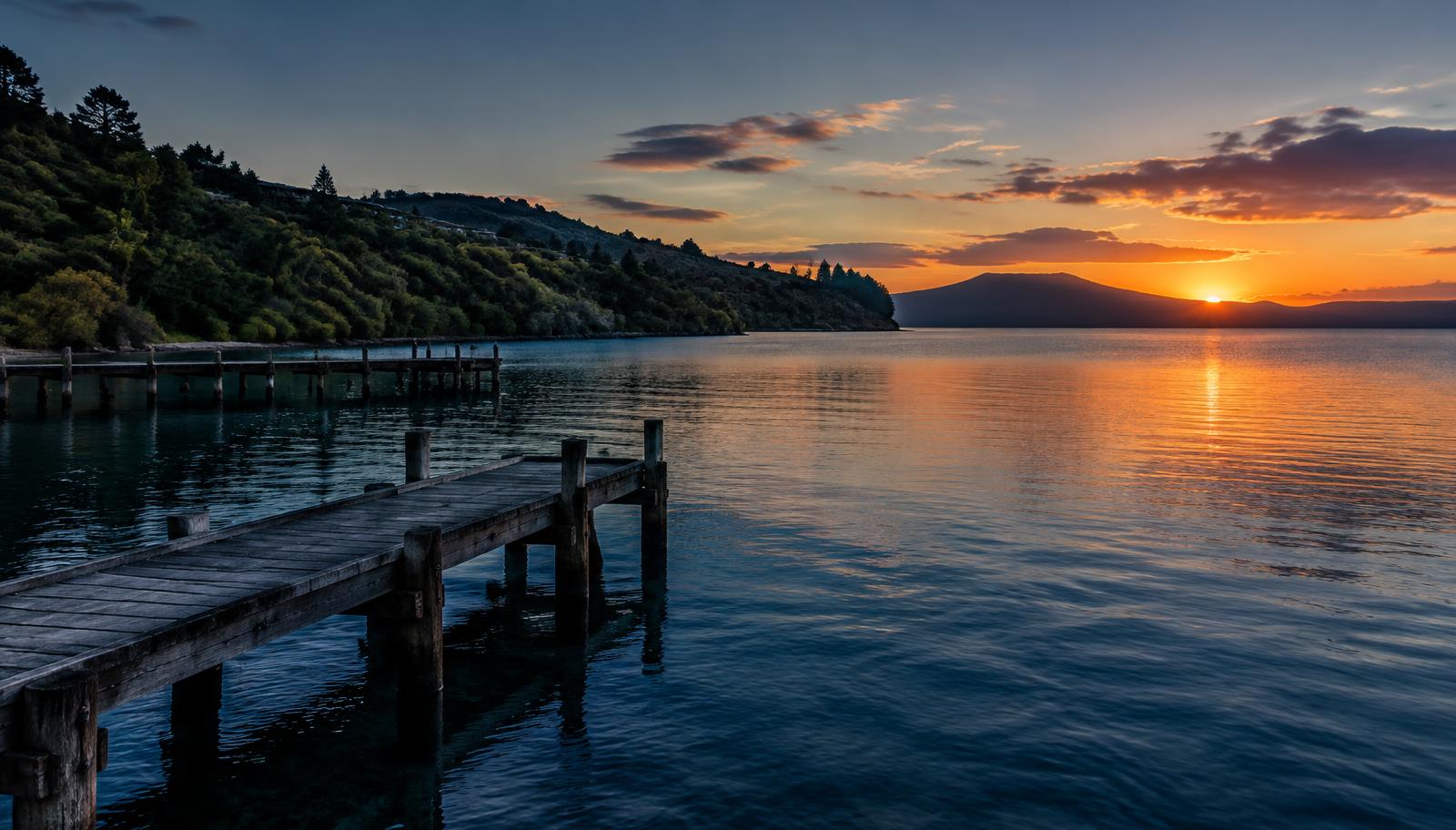 Wooden jetty at Acacia Bay at sunset