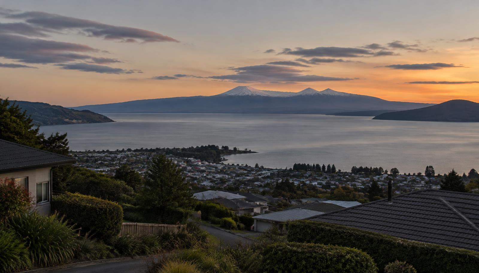 View over Taupō rooftops to the lake and mountains